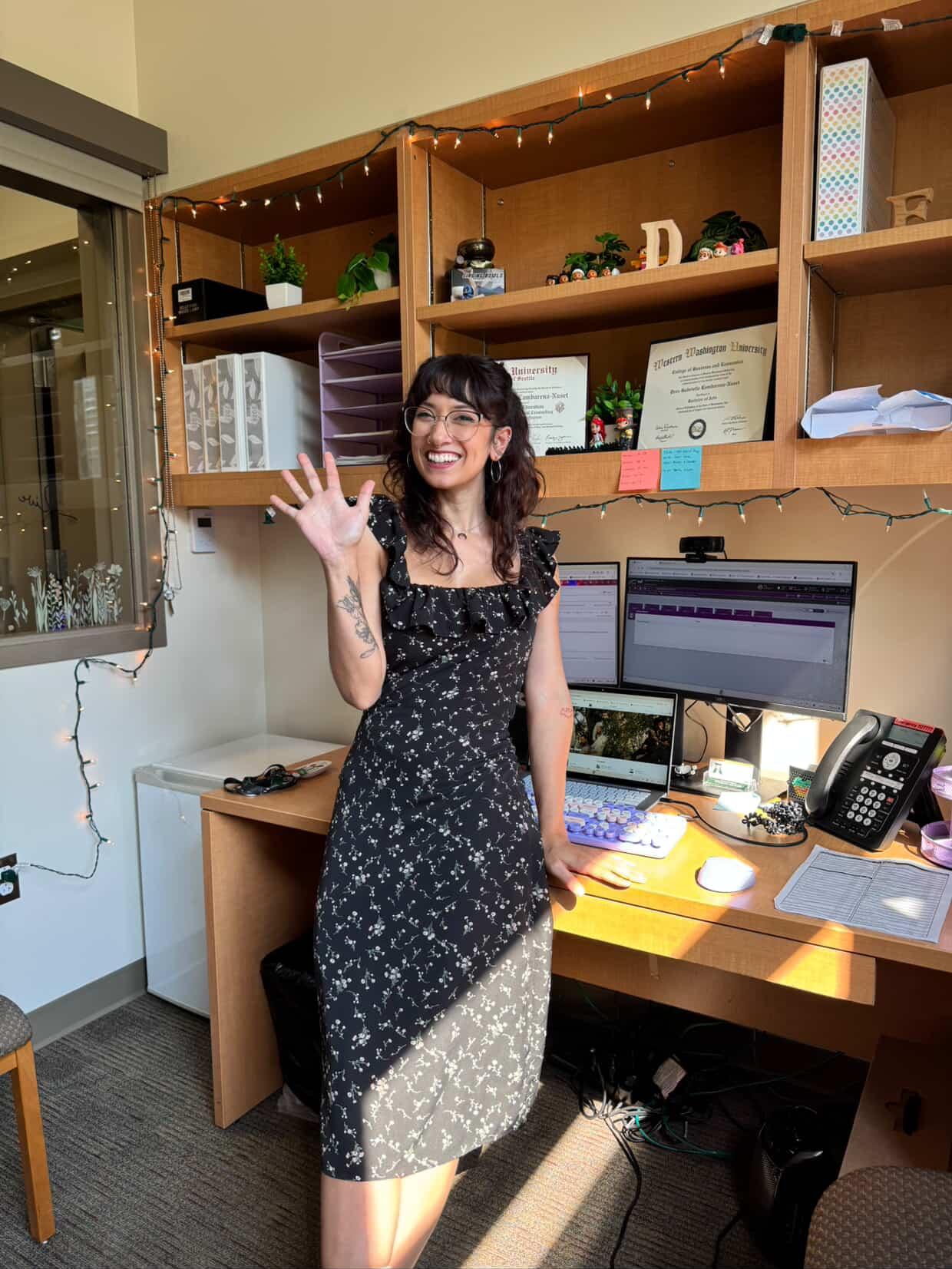 NeuroResilience Coach smiling at desk in a warm, inviting office